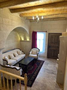 a living room with a couch and a table at Asyada Suites Hotel in Nevsehir