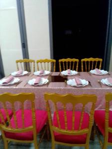 a table with chairs and a table with napkins at CELEBRITES HOTEL in Ouidah