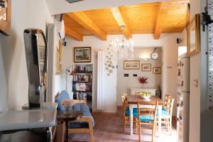 a kitchen and dining room with a table and chairs at The House of Flowers in Vietri