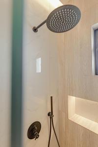 a shower with a shower head in a bathroom at Villa Xhefri in Sarandë