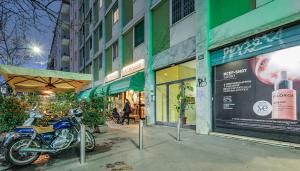 a motorcycle parked on a sidewalk in front of a building at Stylish and Perfect Place for Families and Friends in Milan