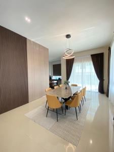 a dining room with a table and chairs at Lodge 16 Private Villa in Kuah