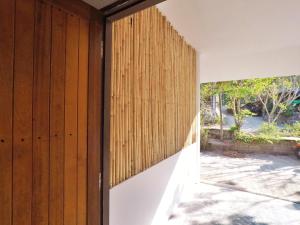 an open door of a house with a wooden wall at Alissia House in Koh Tao