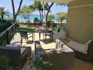 a patio with a table and chairs and the ocean at Villa Luisa B&B in Sperlonga