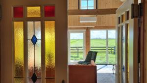 a room with stained glass windows and a chair at City Farmers Lodge, a Guesthouse with a skyline view in Rural Amsterdam in Amsterdam