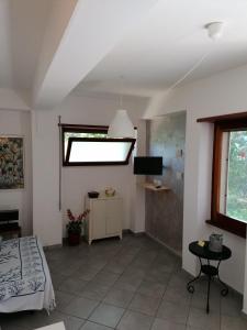 a bedroom with a bed and a window and a television at Villa Luisa B&B in Sperlonga