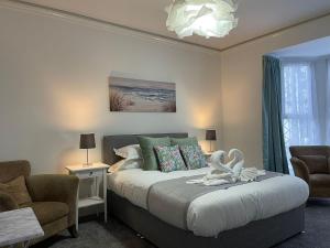 En eller flere senge i et værelse på Tintagel Arms Bed and Breakfast