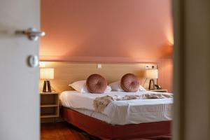 ein Schlafzimmer mit einem Bett mit zwei Kissen darauf in der Unterkunft Boutique Hotel Malleberg in Brügge + 34 Fotos