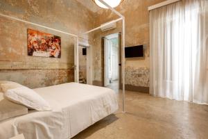 a bedroom with a bed with a metal canopy at Dimore Briganti Gallipoli Centro in Gallipoli