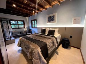 a bedroom with a large bed in a room at Cabana Hippie Eco Boutique in Pirenópolis