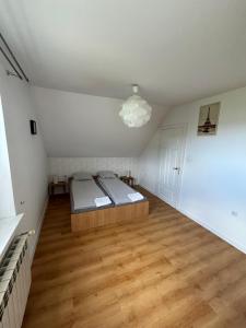 a bedroom with a bed and a wooden floor at Dunajec Home in Chełmiec +35 photos