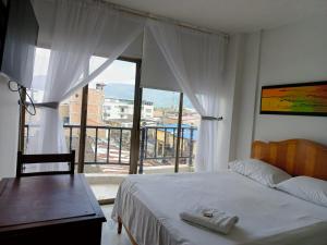 1 dormitorio con cama y ventana grande en HOTEL EJECUTIVO, en Pitalito