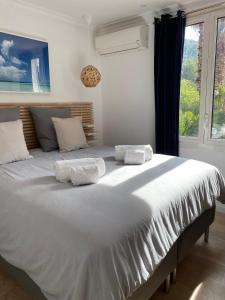 AUBERGE DES PINS في باندول: سرير أبيض كبير في غرفة مع نافذة