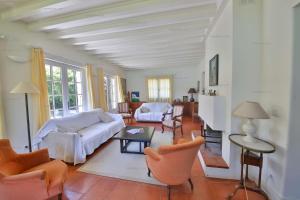 Una sala de estar con un sofá blanco y sillas. en Lac d'Annecy Villa Pieds dans l'eau, en Sévrier