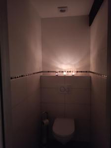 a bathroom with a toilet with lights on it at Romantiksuite bei Seitberger in Frauenberg