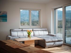 a living room with a couch and a table at Premium Apartments Monterra in Petschnitzen
