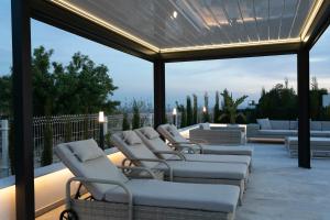 a row of lounge chairs on a patio at Casa Reina Helena - welcome to a special place in Busot