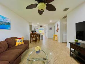 a living room with a couch and a ceiling fan at Fort Myers Beach Escape 3 Miles Away Sleep 7 in Fort Myers Beach