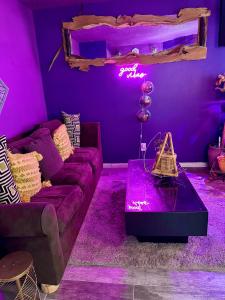 a purple living room with a couch and a table at Zen Life Oasis in Atlanta