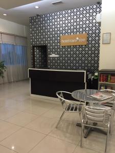 un restaurant avec une table et des chaises dans une salle dans l'établissement Raintree Hotel, à Kuala Lumpur