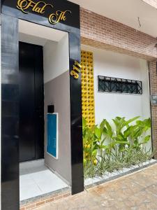 a black door of a building with a sign on it at Flat JK 101 in Juazeiro do Norte