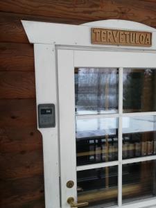 a door to a building with a sign on it at Cottage-karaoke Koivikko in Äänekoski