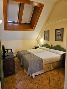 a bedroom with two beds and a window at Hotel Telecabina in Sierra Nevada +47 photos