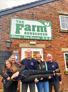a group of people standing in front of a building at The Farm Burscough in Burscough