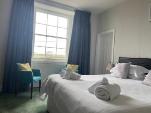 a bedroom with a bed with towels on it at Trevanger Farm Bed and Breakfast in Wadebridge