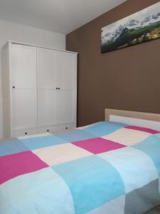 a bedroom with a bed and white cabinets at Apartament Białystok in Białystok