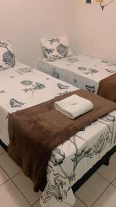 CONFORT HOTEL ARAPIRACA في أرابيراكا: سريرين يجلسون بجانب بعض في غرفة