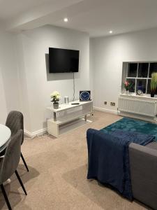 a room with a bed and a tv on a wall at Russell Square Apartment in Brighton & Hove