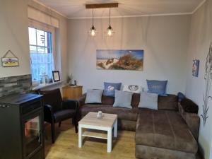 a living room with a couch and a table at Haus Ankerliebe in Dornum