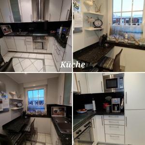 a kitchen with white cabinets and a counter top at Haus Ankerliebe in Dornum