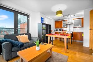 a living room with a couch and a table at Central Flat Pool Table Balcony in Sheffield