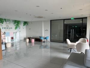 an empty lobby with chairs and tables in a building at Khu Nghĩ Dưỡng Emerald Golf View in Thuan An