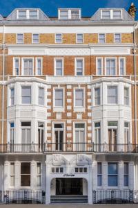 a large brick building with a balcony at Sonder The Gilbert in London
