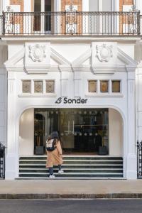 a woman standing in front of a sancer store at Sonder The Gilbert in London