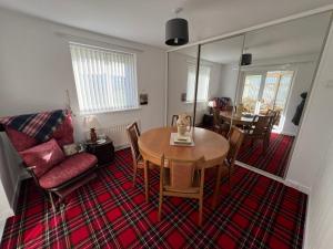 a living room with a table and a couch at Dawson's Corner Retreat in Beadnell