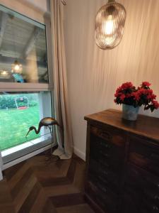 a room with a window with a plant on a dresser at Garda Relais Antica Romelia in Montichiari