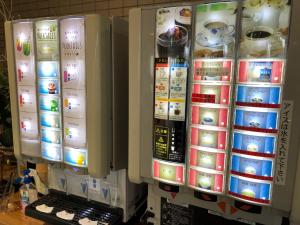 a vending machine with many different types of objects at HOTEL GATE 88 in Naruto
