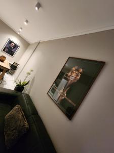 a picture of a woman on a wall at 10th floor, Unit 1008, in The Capital Trilogy, overlooking Sun Time Square in Pretoria