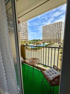 SubaSassy Studio Lapu-Lapu Mactan的阳台配有桌椅,享有建筑的景致。