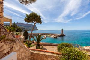 a view of a body of water with a lighthouse at L'aiguade - Cassis in Cassis