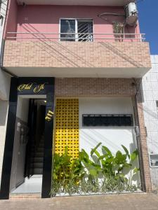 a building with a yellow and white front door at Flat JK 102 in Juazeiro do Norte +17 photos