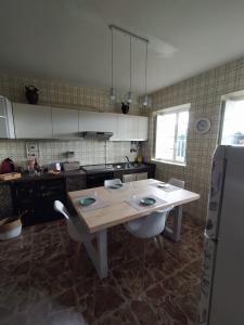 uma cozinha com uma mesa e um frigorífico em Casa Freitas em Combarro