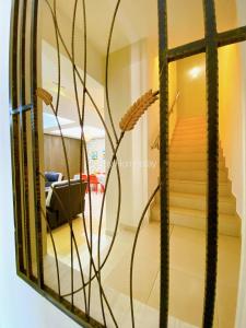 a mirror in a room with a staircase at Idaman Bayu Homestay 4 Bedrooms by DKAY in Sendayan in Seremban