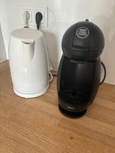 a black and white coffee maker sitting on a table at Olo Apartment in Warsaw