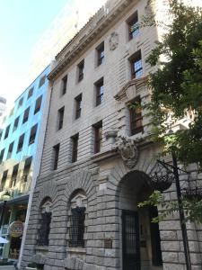 a stone building with an arch in front of it at TAJ Cape Town - Private Luxury One Bedroom Suite in Cape Town