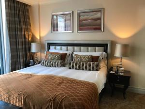 a bedroom with a large bed with pillows on it at TAJ Cape Town - Private Luxury One Bedroom Suite in Cape Town